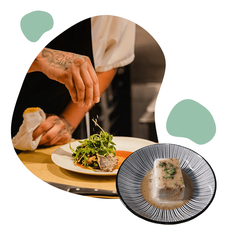 A chef finishing a plate of grilled fish, beside a bowl of steamed tofu